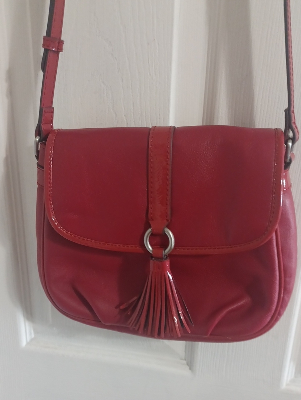 American Learher Company red Leather Crossbody Bag with Tassel Magnetic Closure.